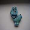 The face flips up to reveal a small metal cup with a waxy perfume in it. I used to wear it on my shirt and smear the smelly goo on my wrists. I was hot.